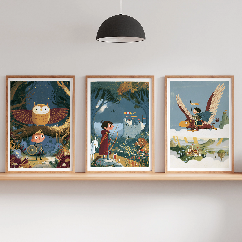Three framed fantasy art prints displayed on a light wood floating shelf against a white wall, with a black pendant lamp above and small potted plants on either side.