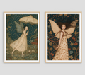 Two framed fairy art prints displayed side-by-side against a light gray wall. The left print shows a fairy in a cream dress holding a parasol under a dark teal rainy sky.