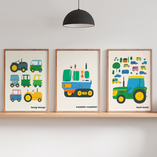 Three framed children's tractor-themed art prints displayed on a wooden shelf in a styled nursery or playroom setting, with a floor lamp, hanging pendant light, and small potted plants.